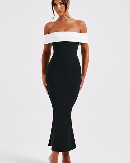 Front view of women's black cocktail midi dress with white off-shoulder pleated detail and black open-toe heels.