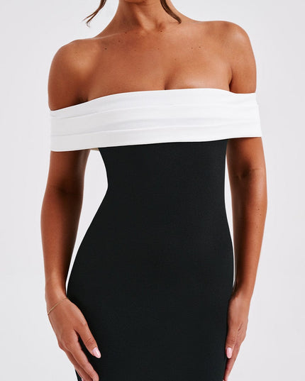 Close-up of the women's black cocktail off-shoulder pleated bardot midi dress, highlighting the white bust detail.