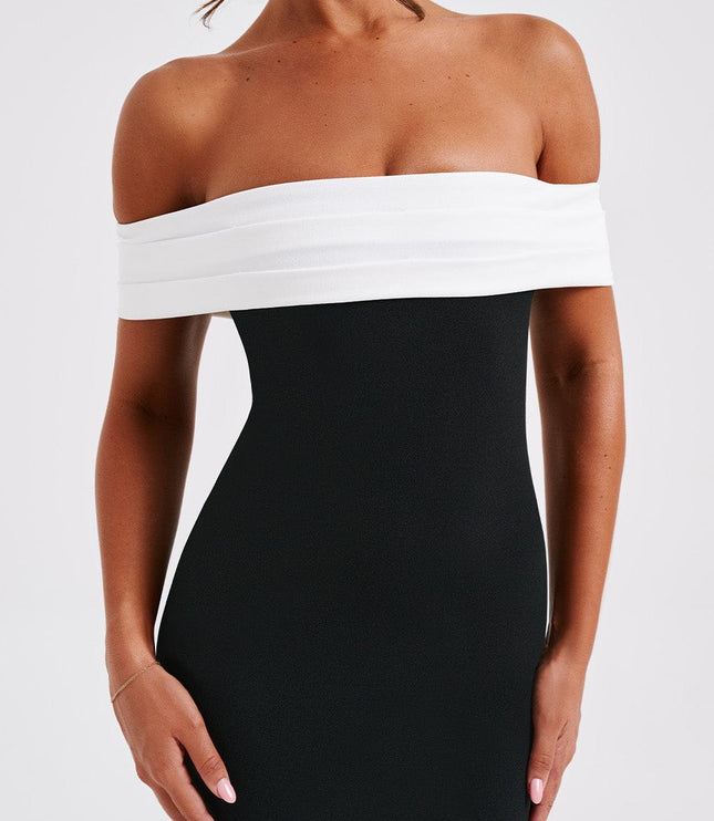 Close-up of the women's black cocktail off-shoulder pleated bardot midi dress, highlighting the white bust detail.