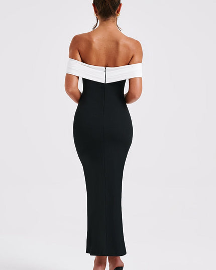 Rear view of the women's black midi dress with white off-shoulder design, showcasing the full length and fitted back.