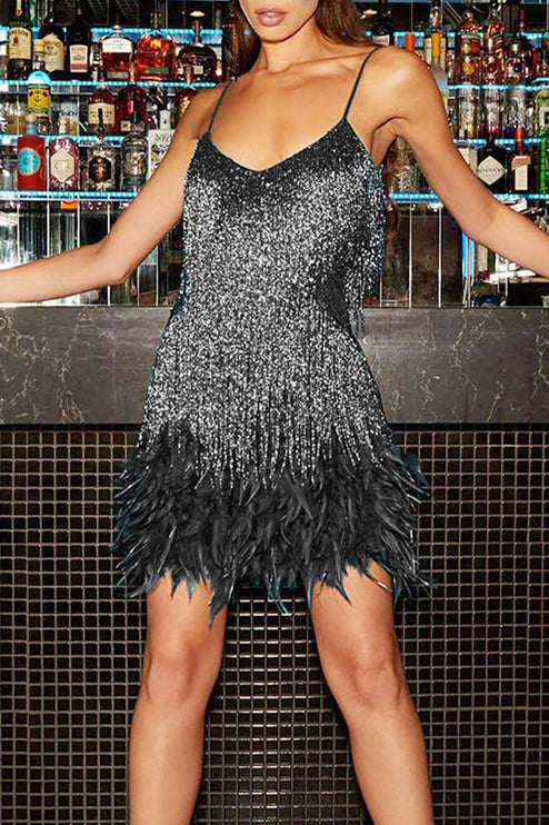 Front view of a woman in a dazzling black and silver sequin fringe feather mini dress, for evenings.