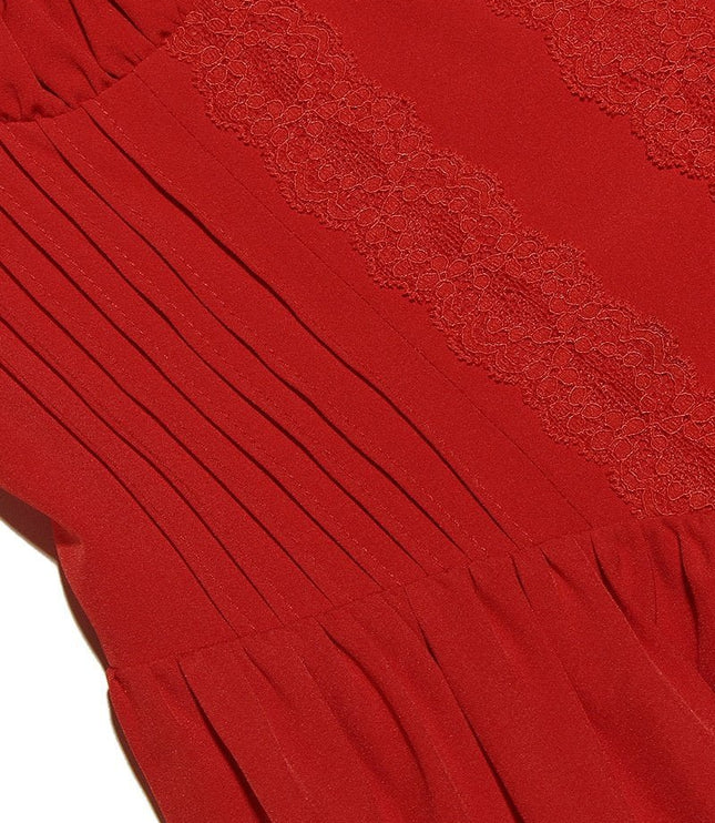 Detail shot of the red fabric of the mini dress, showing the intricate lace trim and vertical pleats on the bodice.
