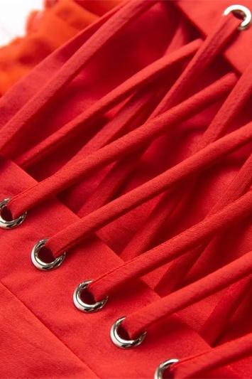Close-up of the red lace-up detail on the back of the corset mini dress, with silver eyelets and crisscross lacing.