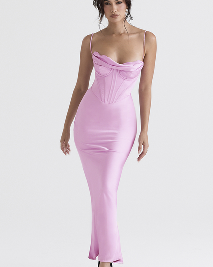 Women's pink satin plunge neck maxi dress with a corset top and delicate straps, captured in a dynamic pose against a white background.