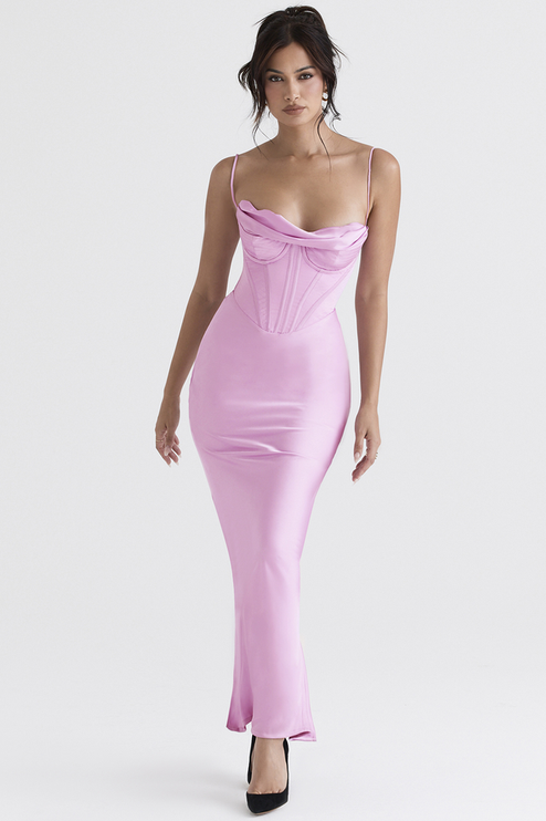 Women's pink satin plunge neck maxi dress with a corset top and delicate straps, captured in a dynamic pose against a white background.