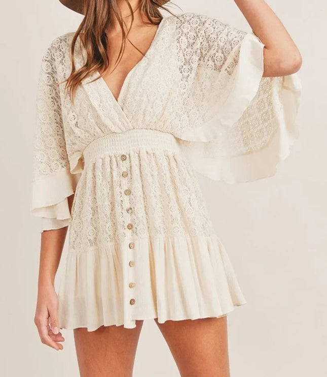 Front view of a cream lace V-neck mini romper featuring a smocked waist and delicate button details.