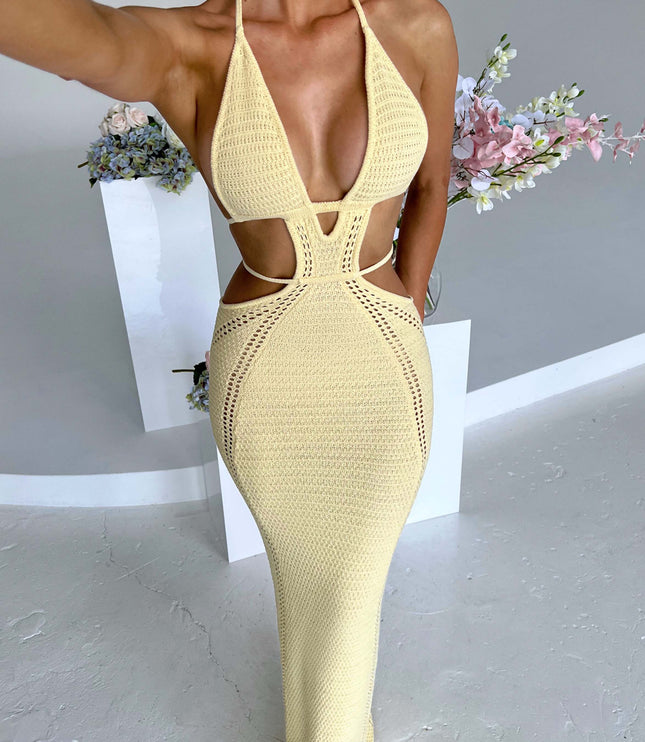 Full-length view of a women's yellow crochet knit plunge halter cut out maxi dress, featuring intricate side cut-outs and a flowing skirt.