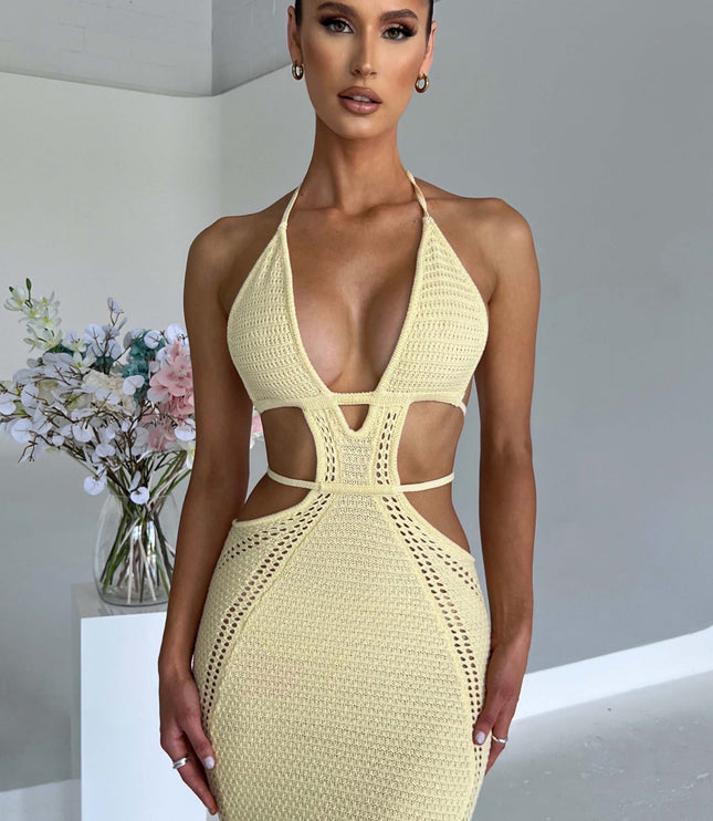 Close-up front view of the light yellow crochet knit maxi dress, focusing on the plunge neckline and geometric cut-outs.