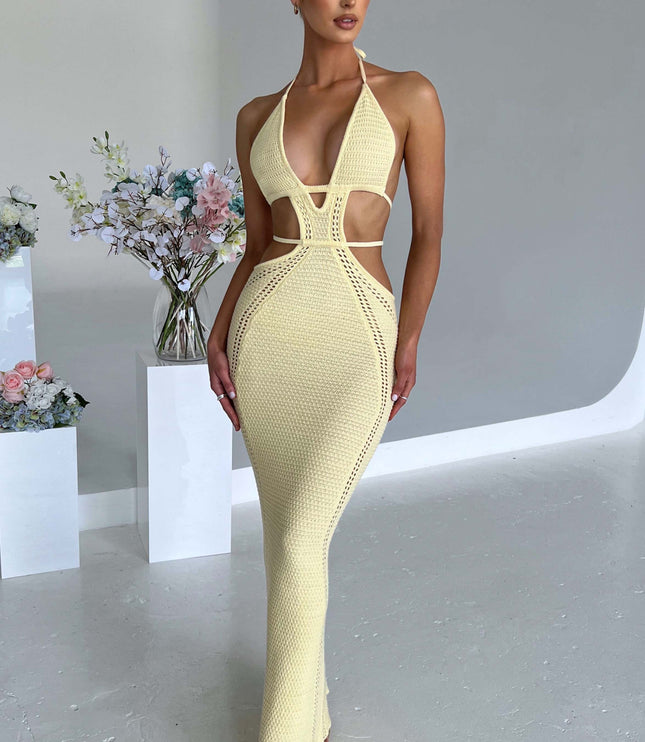 Standing shot of a woman in a light yellow crochet knit plunge halter cut-out maxi dress, for a summer event.