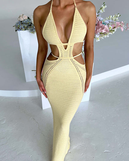 Full-length view of a women's light yellow crochet knit maxi dress with a deep plunge halter neckline and intricate side cut-outs.