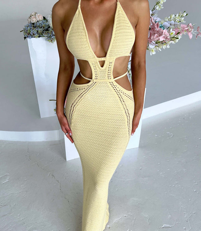 Full-length view of a women's light yellow crochet knit maxi dress with a deep plunge halter neckline and intricate side cut-outs.