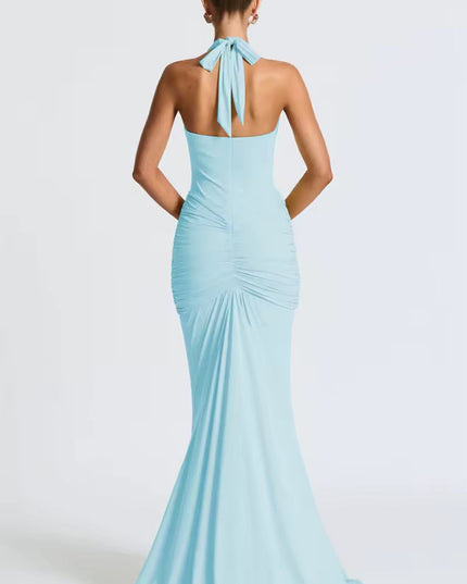 Back view of a light blue women's halter ruched mermaid maxi dress, showing the tied neck and flowing skirt.