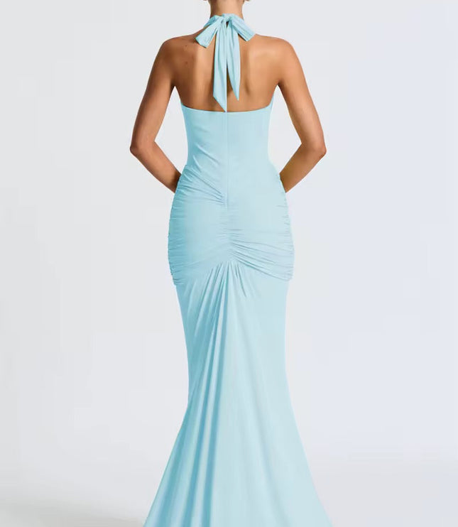 Back view of a light blue women's halter ruched mermaid maxi dress, showing the tied neck and flowing skirt.