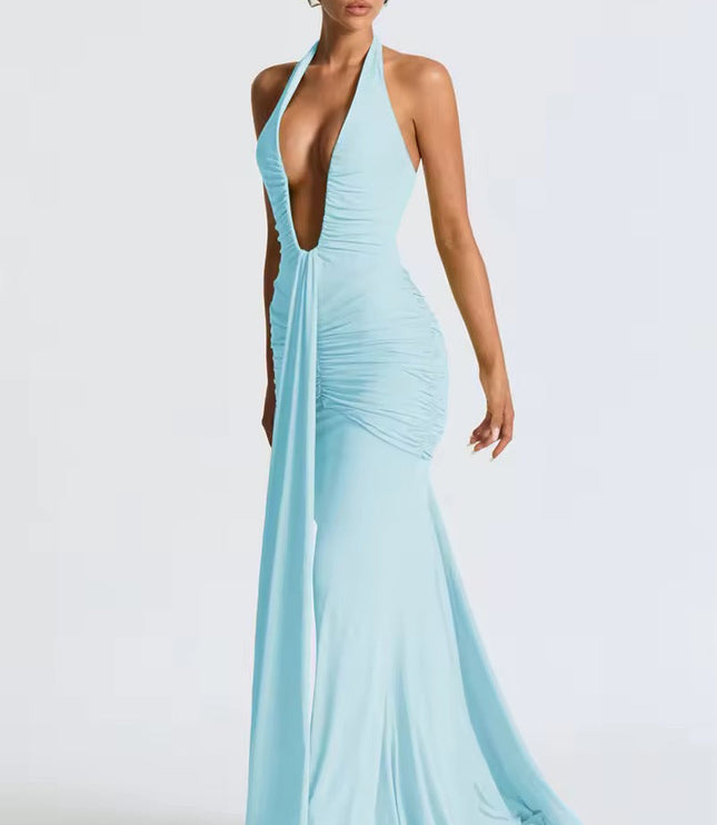 Side profile of a women's light blue deep V halter ruched mermaid maxi dress, showcasing the silhouette and ruching.
