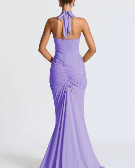 Back view of a lavender women's halter ruched mermaid maxi dress, with tied neck and elegant train.