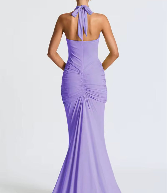 Back view of a lavender women's halter ruched mermaid maxi dress, with tied neck and elegant train.