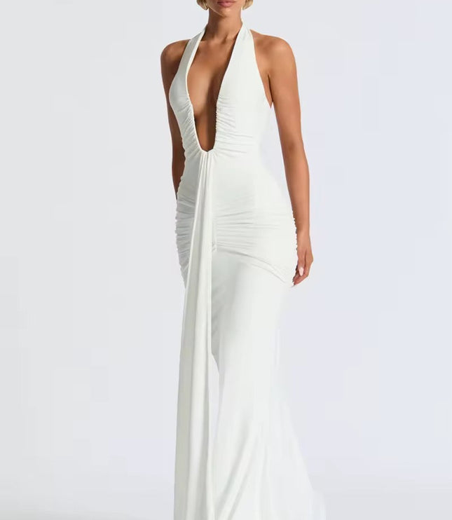 Angled view of a white deep V halter ruched mermaid maxi dress, showing the elegant drape and floor-length design.