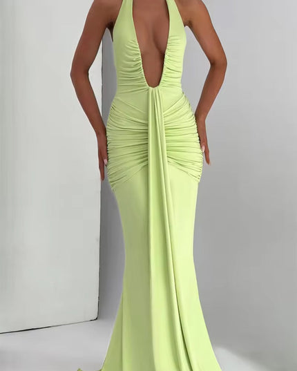 Full body shot of a light green deep V halter ruched mermaid maxi dress, showcasing the elegant floor-length design.