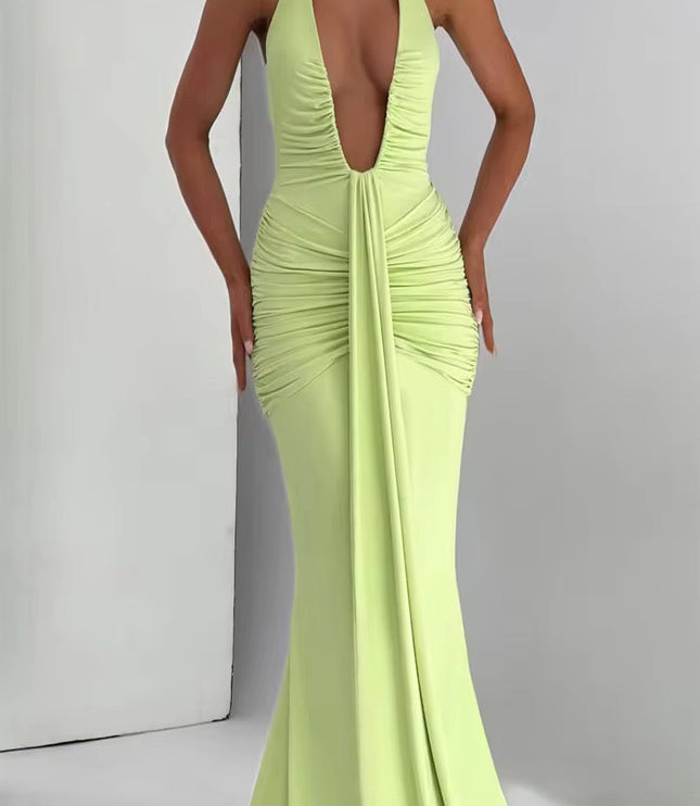 Full body shot of a light green deep V halter ruched mermaid maxi dress, showcasing the elegant floor-length design.