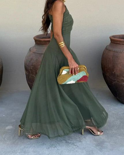 Side view of olive green one-shoulder mesh maxi dress, showcasing the full skirt and gold high heels.