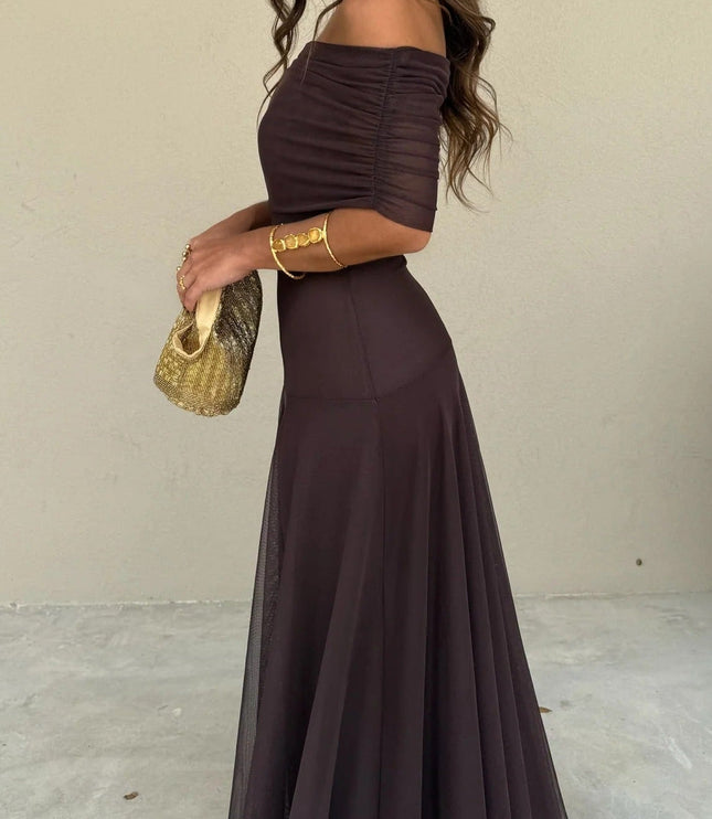 Full side view of a women's chocolate brown off-the-shoulder mesh maxi dress, showcasing the flowing skirt.