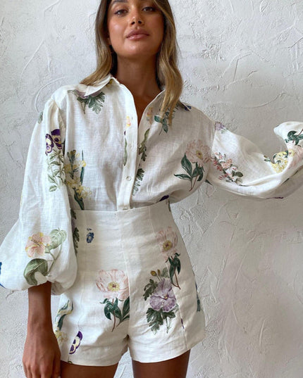 Frontal view of women's white linen floral short set, emphasizing the elegant balloon sleeves and high-waisted shorts.