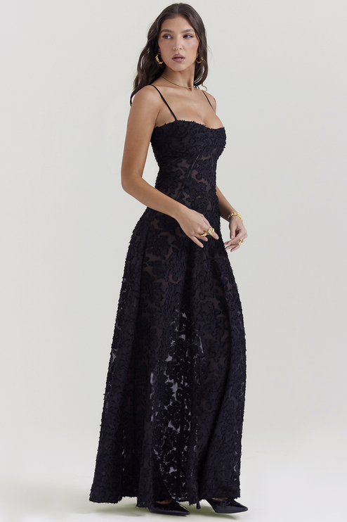 Side view of women's black floral corset maxi dress, highlighting the flowing skirt and fitted bodice.