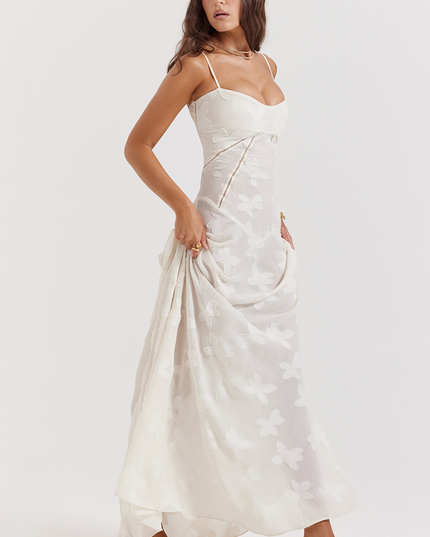 White floral corset maxi dress with a full skirt and butterfly- floral texture, worn with white heeled sandals, showcasing the dress's movement.