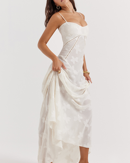Side view of a white floral corset maxi dress with a full skirt, showing the intricate butterfly- pattern and the dress's flow.