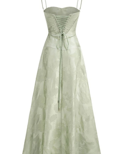Back view of the light green floral corset maxi dress, highlighting the full lace-up detail and flowing skirt.
