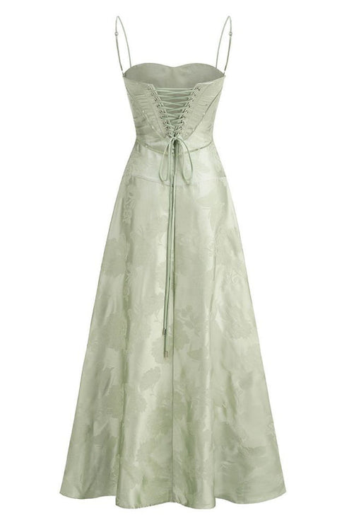 Back view of the light green floral corset maxi dress, highlighting the full lace-up detail and flowing skirt.