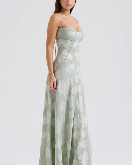 Side view of women's light sage floral corset maxi dress, highlighting the fitted bodice and flowing skirt.