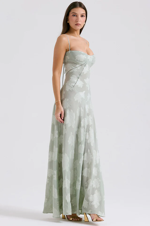 Side view of women's light sage floral corset maxi dress, highlighting the fitted bodice and flowing skirt.