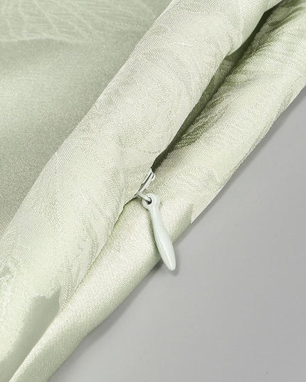 Detail of the hidden zipper closure on the side of the light green floral corset maxi dress.