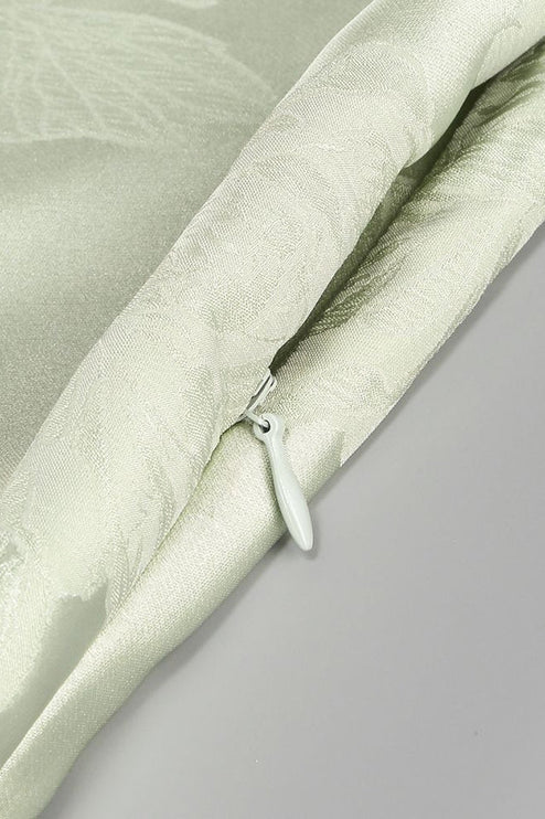Detail of the hidden zipper closure on the side of the light green floral corset maxi dress.