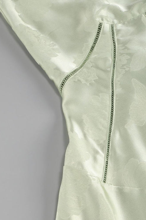 Close-up of the light green floral maxi dress bodice, showing the side panel with decorative stitching.