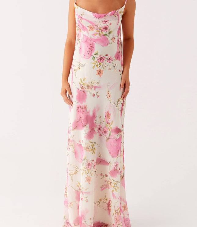 Full length front view of a women's floral cowl neck maxi dress, showcasing the pink and green pattern.