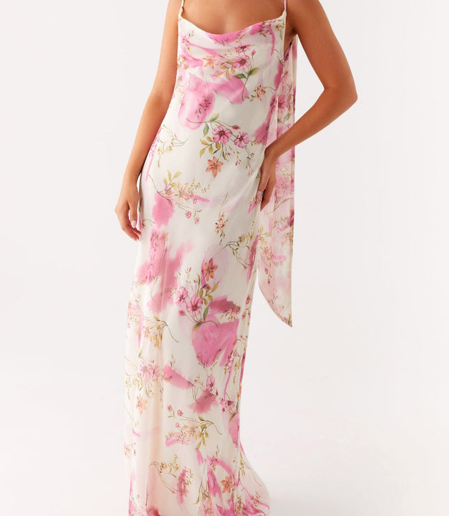 Front view of a women's floral cowl neck maxi dress with pink pattern, showing one arm raised.