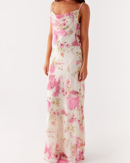 Front view of a women's white maxi dress with pink floral print and cowl neck detail.