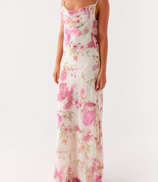 Front view of a women's white maxi dress with pink floral print and cowl neck detail.