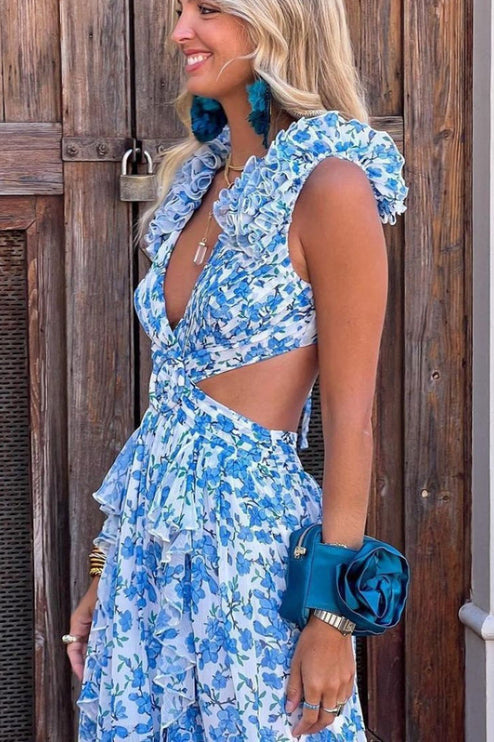 Side profile of women's blue and white floral print maxi dress, highlighting the ruffled sleeves, V-neck, and side cut-outs.
