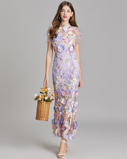Full-length view of a women's lavender floral embroidered sheer maxi prom dress with short sleeves and a basket.