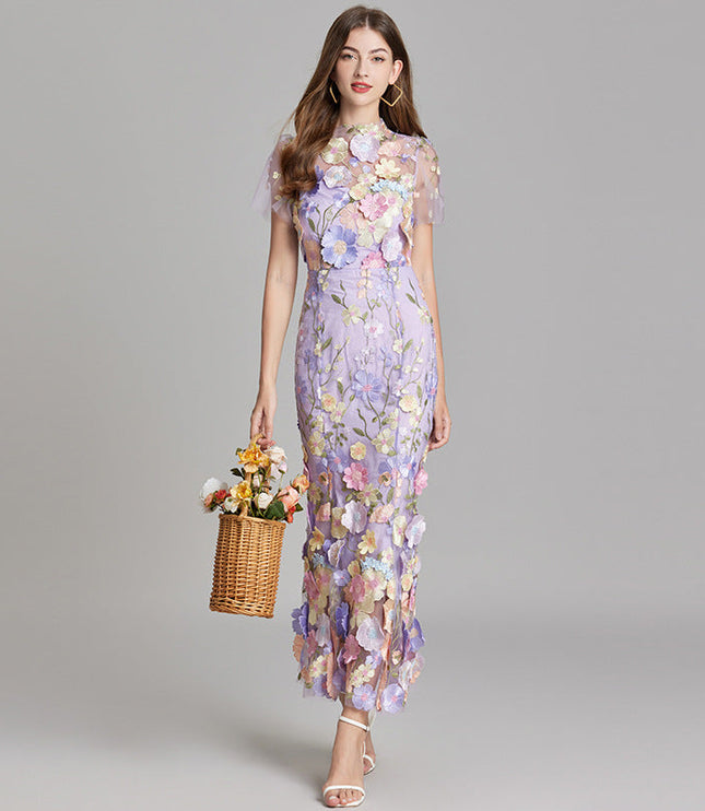 Full-length view of a women's lavender floral embroidered sheer maxi prom dress with short sleeves and a basket.