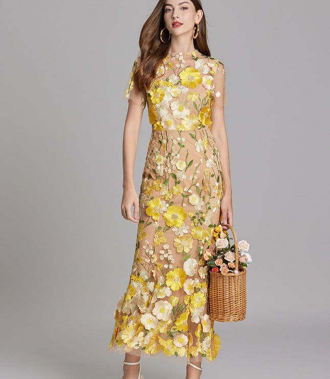 Women's yellow and white floral embroidered sheer maxi prom dress, short sleeves, with a basket of flowers.