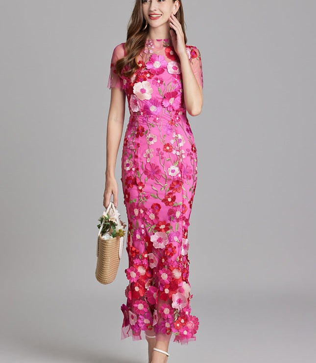 Elegant women's vibrant pink floral embroidered sheer maxi prom dress, showcasing the intricate flower details and sheer fabric.