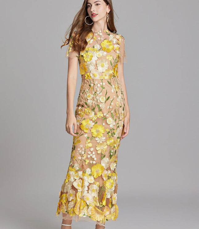 Front view of women's yellow and white floral embroidered sheer maxi prom dress, short sleeves, in a gentle pose.