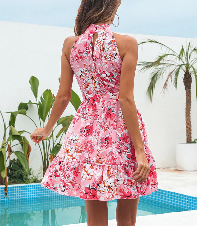 Back view of a pink floral halter neck tiered mini dress with a keyhole opening.