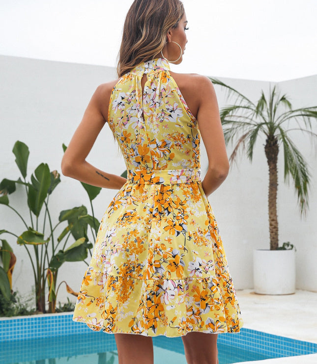 Back view of the women's yellow floral halter neck mini dress, featuring a keyhole detail and tied belt.