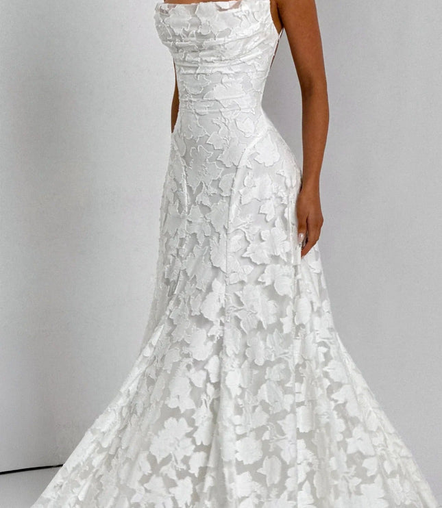Side profile of a women's white floral jacquard maxi dress, highlighting the textured fabric and elegant fit.