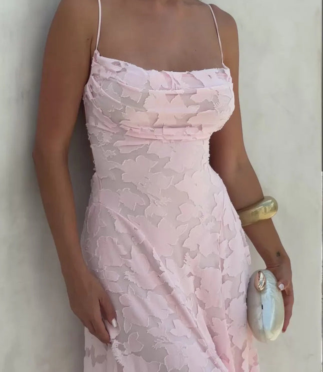 Close-up of a women's pink floral jacquard maxi dress, showing the intricate lace-up back detail and textured fabric.